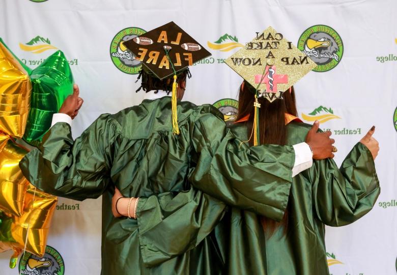 2 graduates in cap and gown